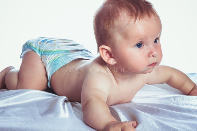Beautiful blue-eyed baby in diapers stock image Beautiful blue-eyed baby in diapers stock image