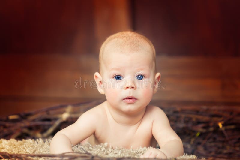 Beautiful blue-eyed baby lying on tummy stock photo Beautiful blue-eyed baby lying on tummy stock photo