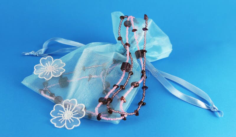 Beautiful blue silk bag with beaded necklace