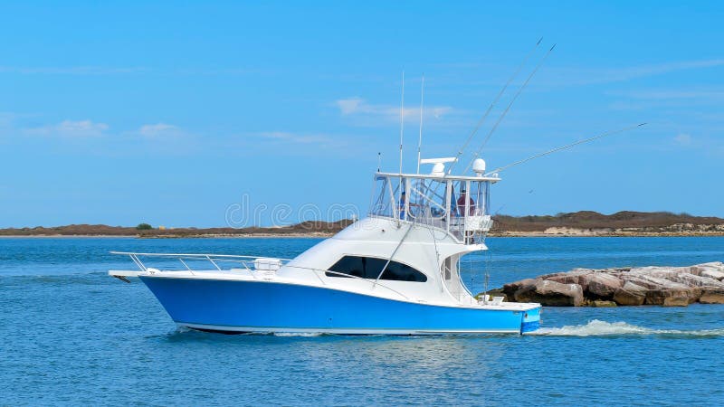 Beautiful blue and white fishing yacht boat on the water on sunny day