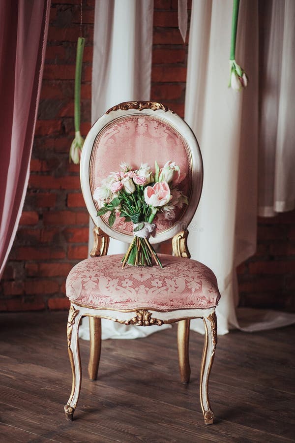 Beautiful bouquet of colorful flowers on a vintage chair, preparing for the wedding, details, boudoir