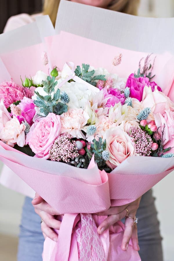 Beautiful bouquet in pink wrapping paper. Roses and other delicate beautiful flowers royalty free stock image Beautiful bouquet in pink wrapping paper. Roses and other delicate beautiful flowers royalty free stock image