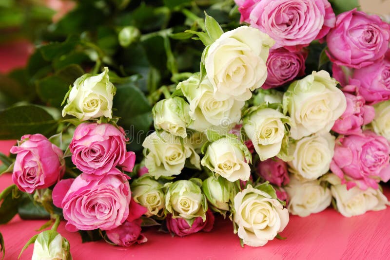 Beautiful bouquet of white and pink roses on pink background