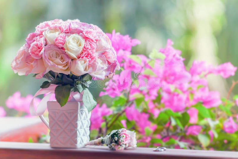 Beautiful bridal bouquet of roses on a green background