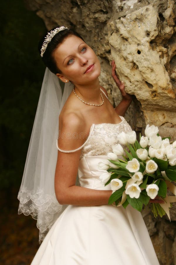 Beautiful the bride with a bouquet from tulips. Beautiful the bride with a bouquet from tulips