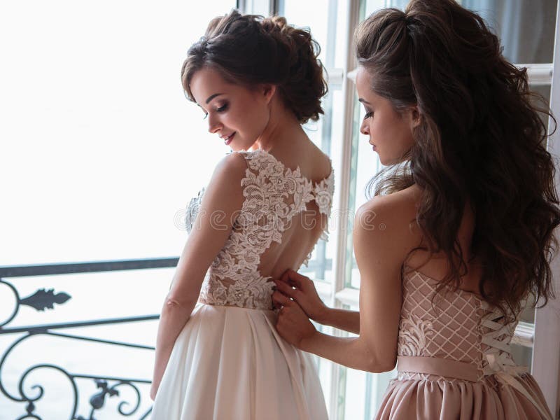 Beautiful bride and bridesmaids in luxury dresses.