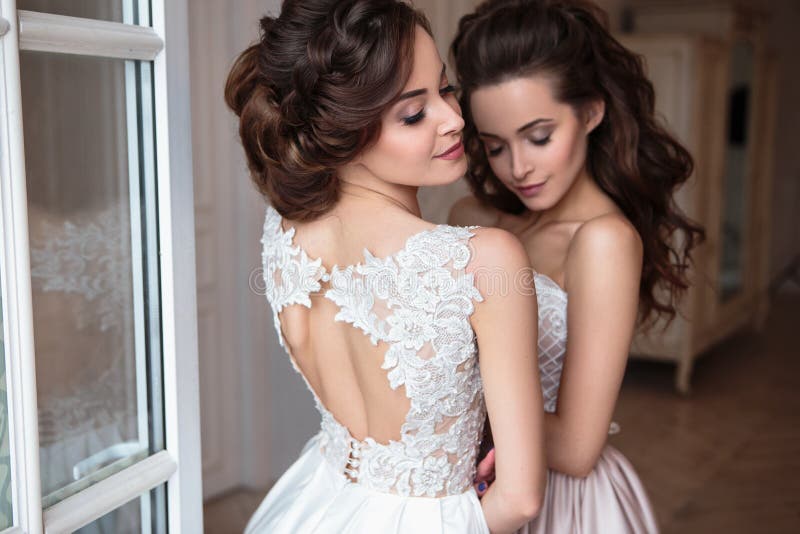 Beautiful bride and bridesmaids in luxury dresses.