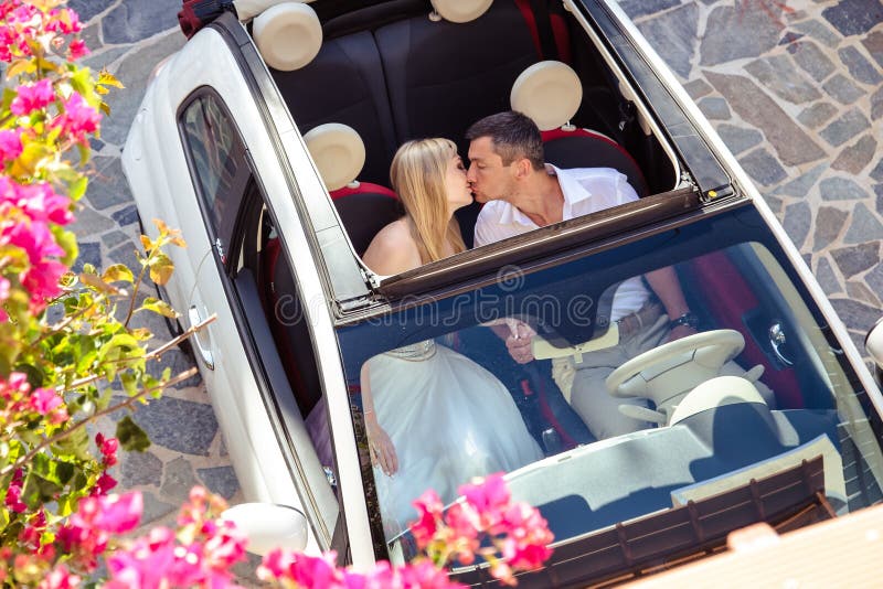 Beautiful bride and groom in their summer wedding day on greek island Santorini