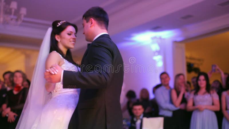 Beautiful bride and handsome groom dancing first dance at the wedding party