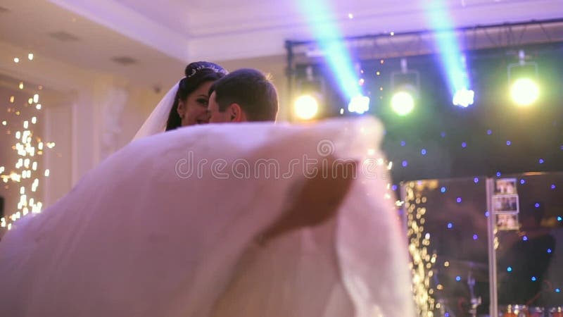 Beautiful bride and handsome groom dancing first dance at the wedding party