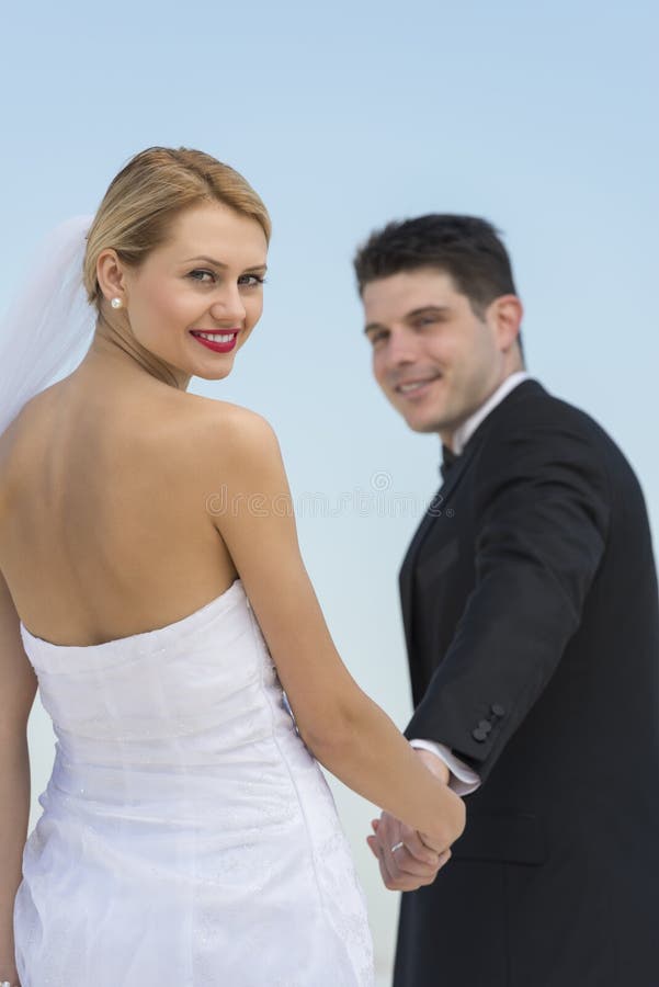 Beautiful Bride Holding Groom's Hands Against Clear Blue Sky stock images Beautiful Bride Holding Groom's Hands Against Clear Blue Sky stock images