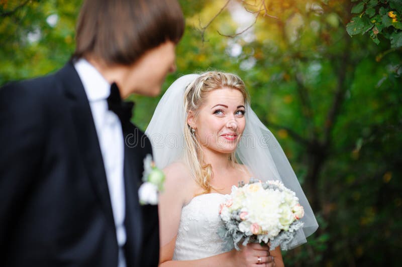 Beautiful bride looking over her shoulder and smiling royalty free stock photo Beautiful bride looking over her shoulder and smiling royalty free stock photo