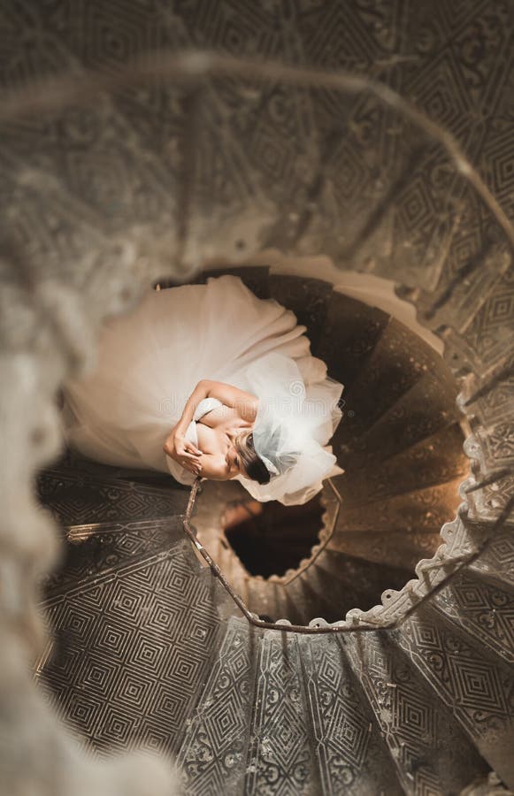 Download Beautiful Bride In Magnificent Dress Stands Alone On Stairs Stock Photo - Image of hair, beauty: 108901754
