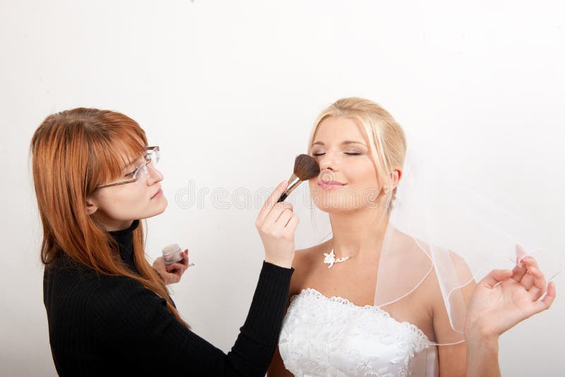 Beautiful bride and make-up artist