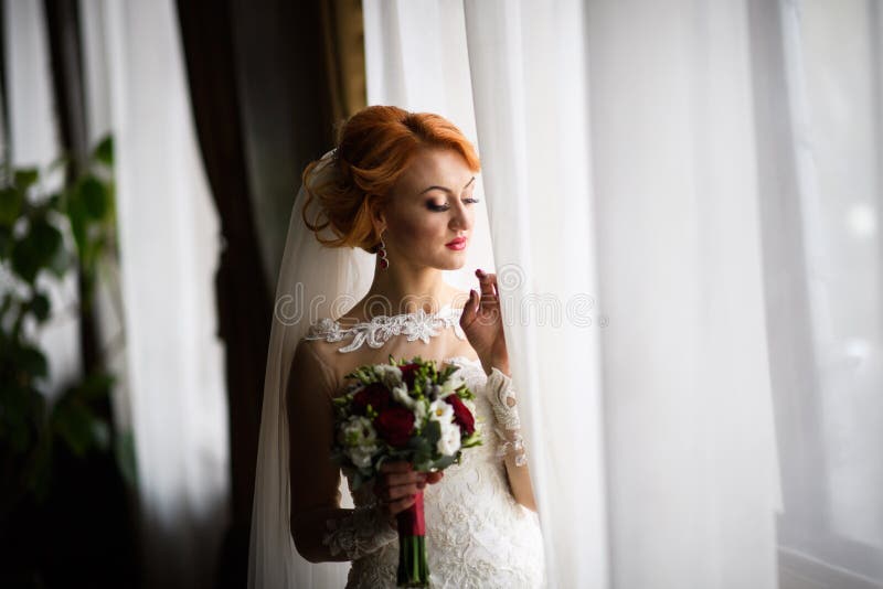 Beautiful bride portrait wedding makeup and hairstyle, Bride in veil and jewelry at home. Bride wedding morning