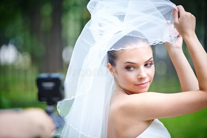 Beautiful bride posing for videographer