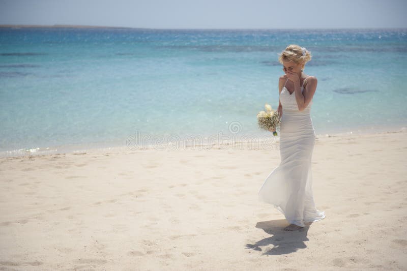 Beautiful bride on a tropical beach wedding day