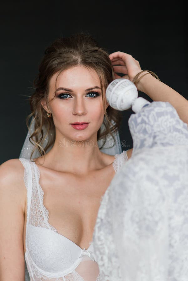 Beautiful Bride In White Lingerie Lying On The Bed In Her Bedroom Stock