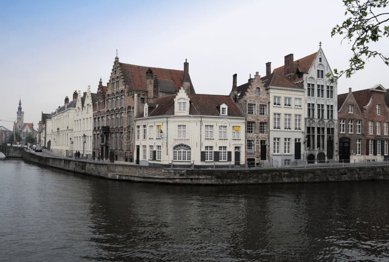 This photograph represent old beautiful houses on a canal in beautiful city of Brugge, Belgium. This photograph represent old beautiful houses on a canal in beautiful city of Brugge, Belgium