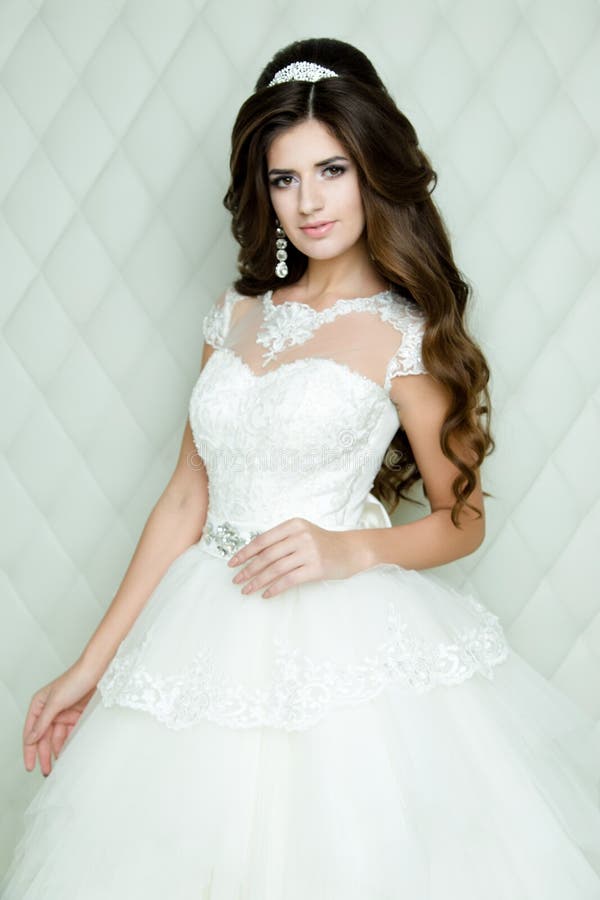 Beautiful brunette Bride portrait wedding makeup and hairstyle with diamond crown