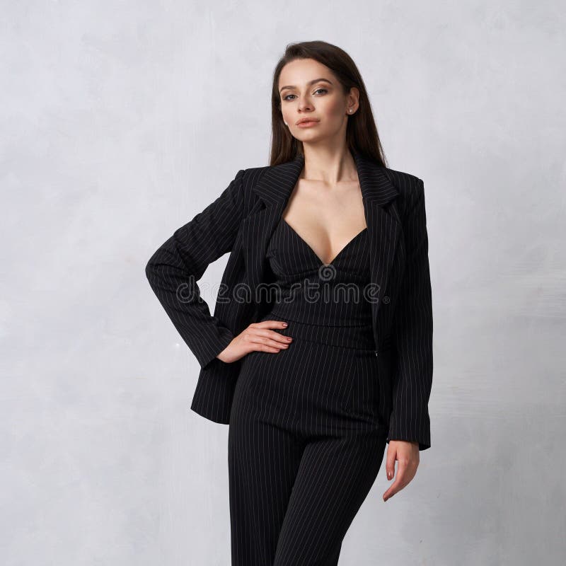 Beautiful brunette girl in black striped jumpsuit and blazer royalty free stock photography Beautiful brunette girl in black striped jumpsuit and blazer royalty free stock photography