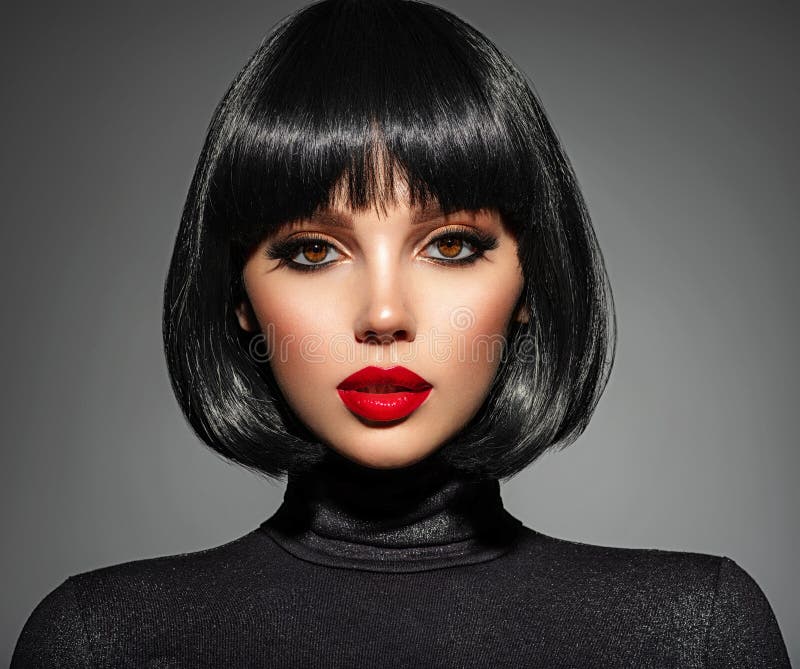Beautiful brunette girl with red lips and black bob hairstyle. Pretty young woman with black hair. Closeup portrait of a model. With bright makeup on a face
