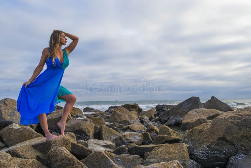 Lovely Brunette Latin Model Poses Outdoors On A Beach At Sunset Stock