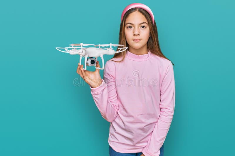 Beautiful Brunette Little Girl Using Drone Thinking Attitude and Sober ...