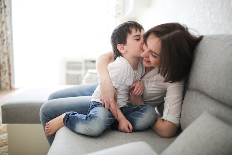 Beautiful Brunette Mom And Son Hugging Sofa Stock Image Image Of