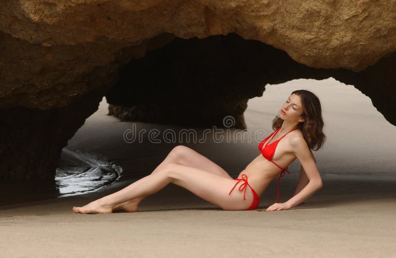 Beautiful Brunette Woman Posing At The Beach In Red Bikini Stock Photo