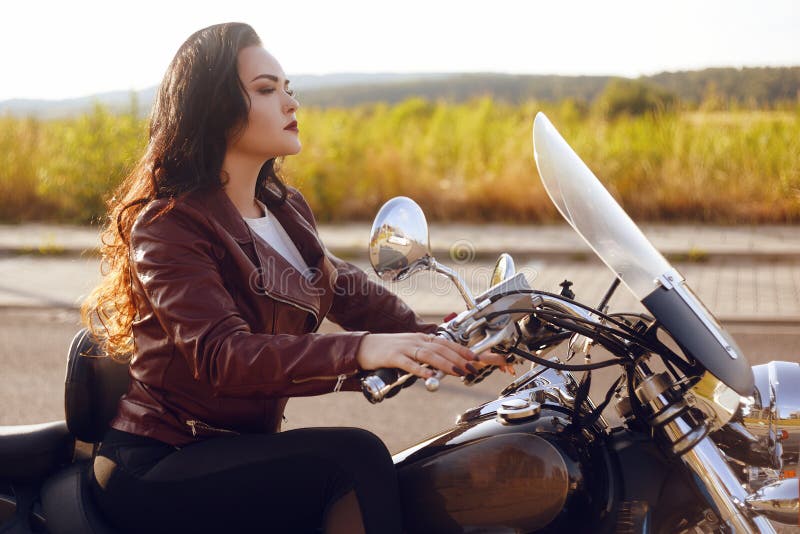 Beautiful Brunette in a Red Leather Jacket on a Motorcycle in the Field.  Girl with Beautiful Hair Stock Image - Image of caucasian, female: 153245731
