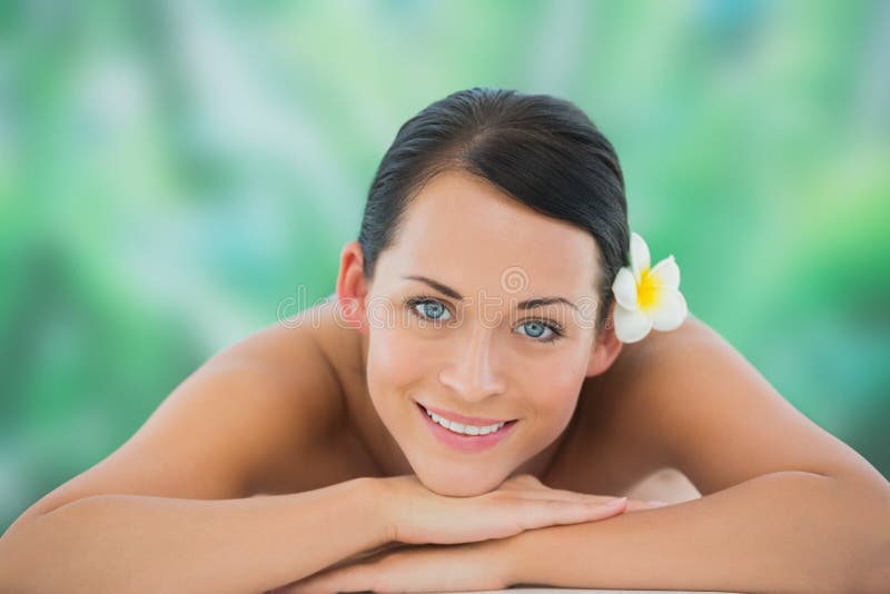 Beautiful Brunette Relaxing On Massage Table Smiling At Camera Stock