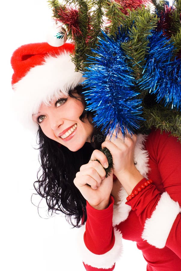 Beautiful brunette woman carrying a Christmas tree