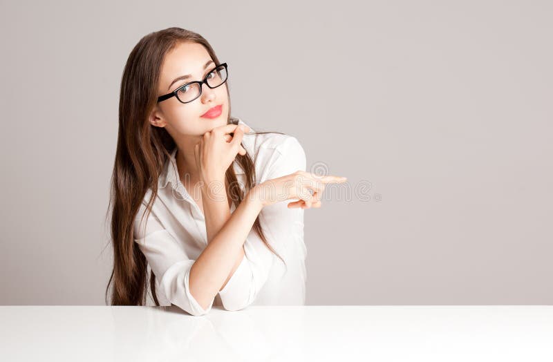 Portrait of a beautiful brunette woman pointing with index finger. Portrait of a beautiful brunette woman pointing with index finger.