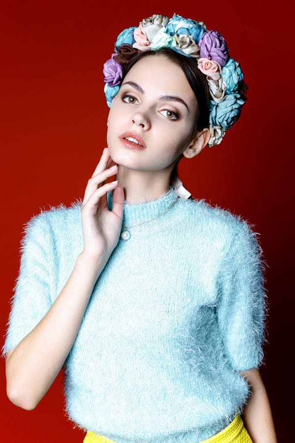 Beautiful brunette woman with a wreath of flowers on her head.