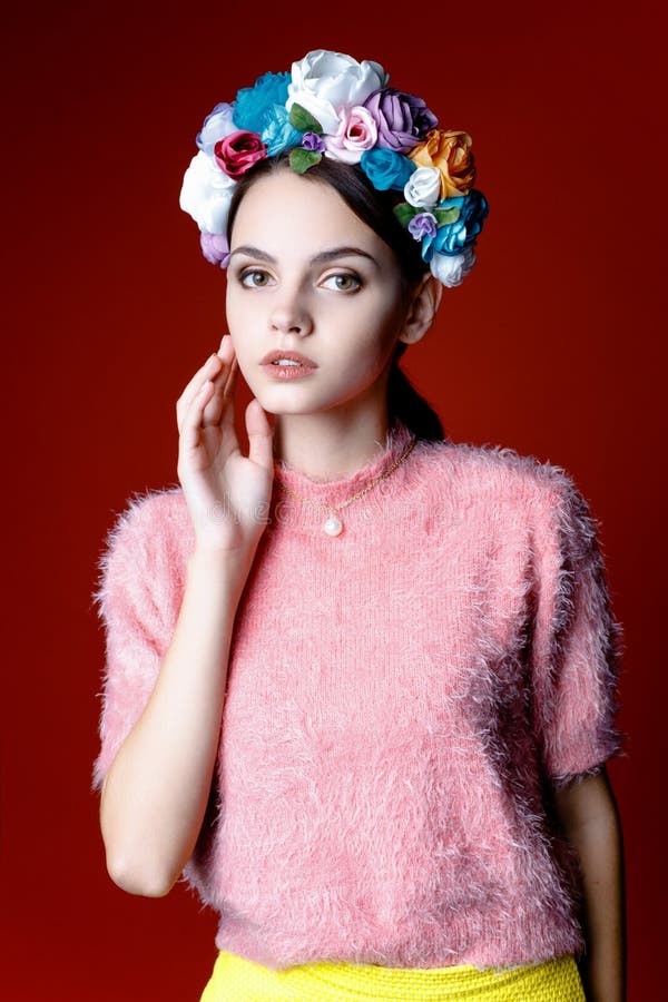 Beautiful brunette woman with a wreath of flowers on her head.