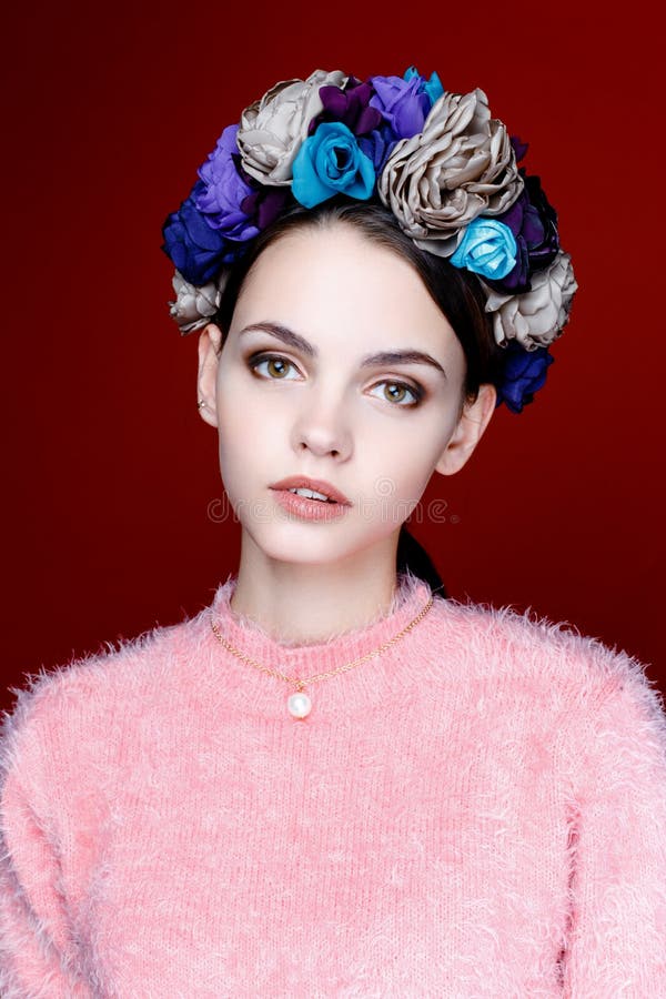 Beautiful brunette woman with a wreath of flowers on her head.