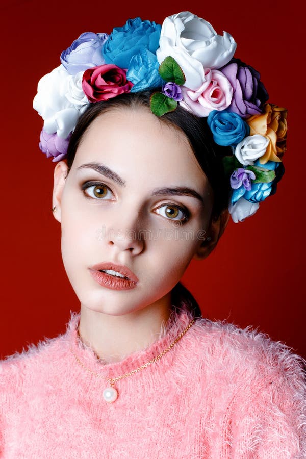 Beautiful brunette woman with a wreath of flowers on her head.