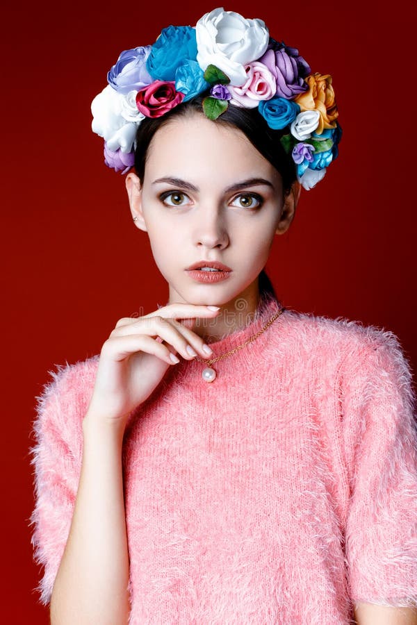 Beautiful brunette woman with a wreath of flowers on her head.