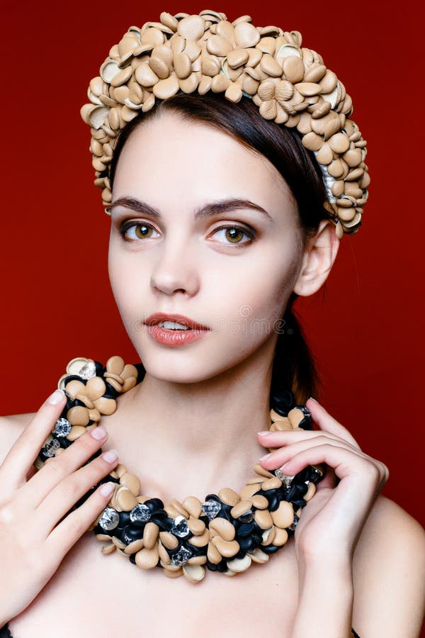 Beautiful brunette woman with a wreath of flowers on her head.