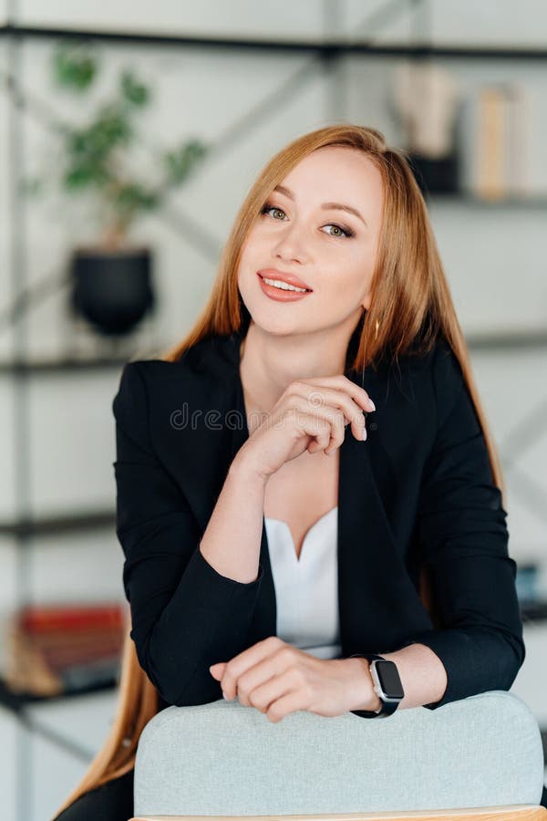Beautiful Businesswoman in Black Business Suit on a Chair. Stock Photo ...