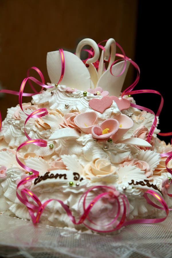 Beautiful cake for wedding with figures of swans closeup stock image Beautiful cake for wedding with figures of swans closeup stock image