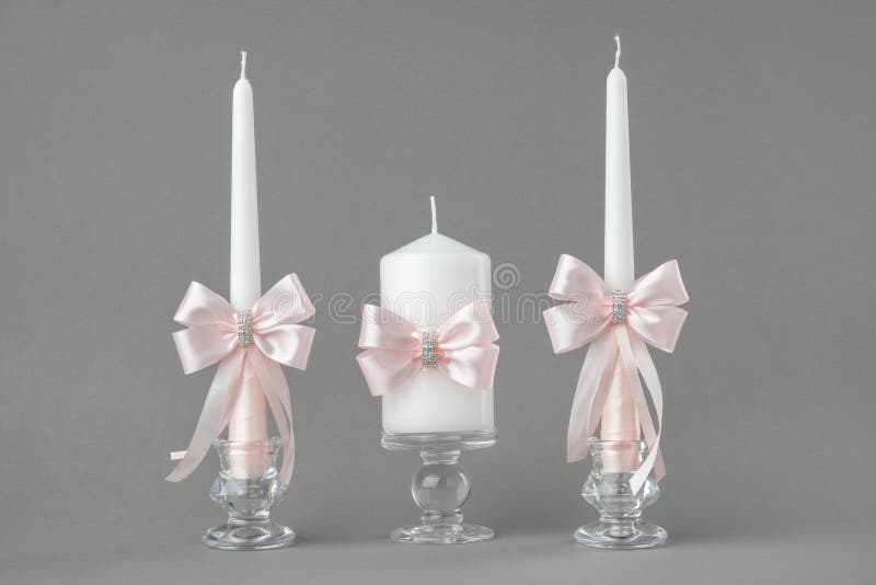 Beautiful candles decorated with pink bows. stock photography