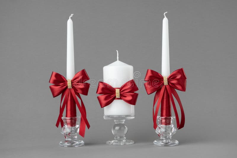 Beautiful candles decorated with red bows. stock photo