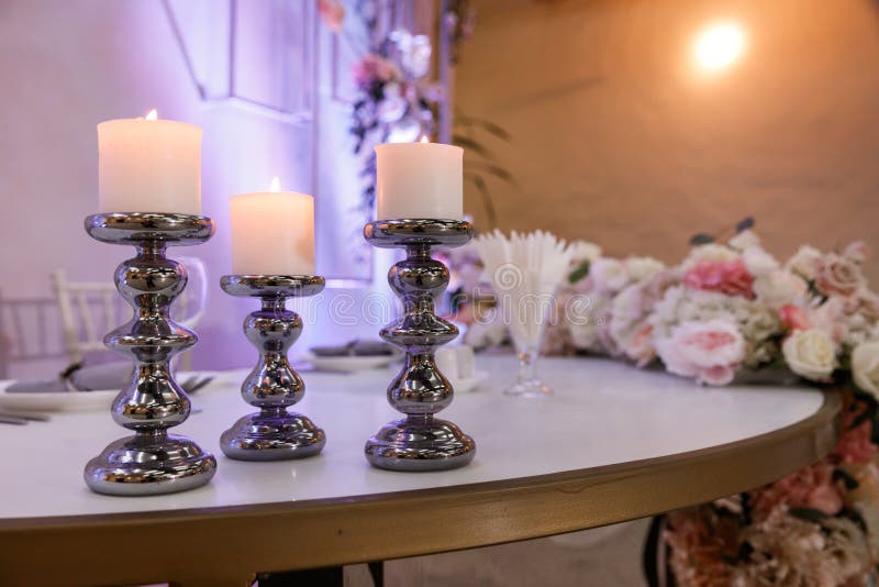Beautiful Candles in Silver Candlesticks on the Festive Table Stock