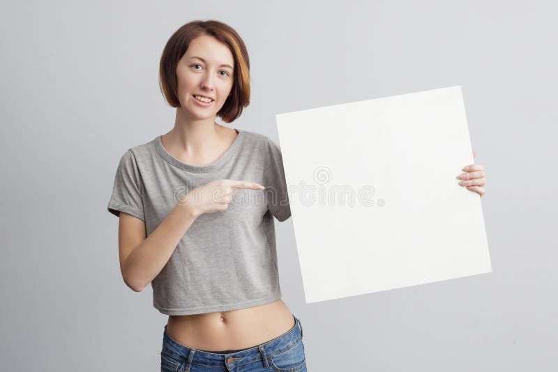 Beautiful caucasian girl holding a blank poster for text or ad. stock photography Beautiful caucasian girl holding a blank poster for text or ad. stock photography