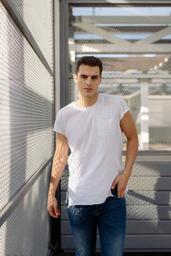Beautiful Caucasian Man in White T-shirt and Blue Jeans Stay on the ...