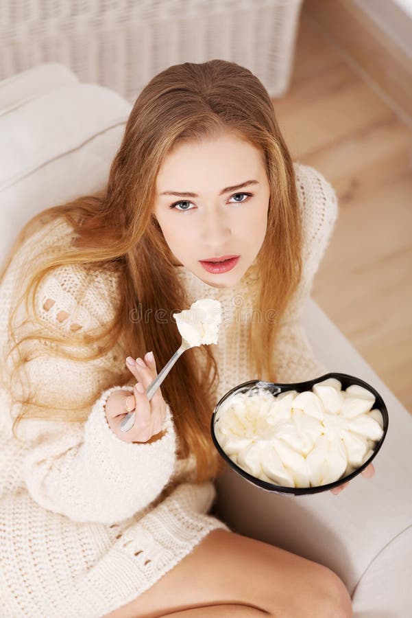 Beautiful Caucasian Sad Woman Eating Ice Creams. Stock Image - Image of