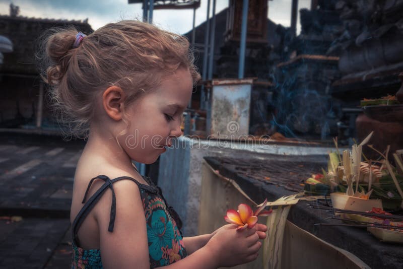 Beautiful child girl praying in temple concept for hope faith and peace stock photography