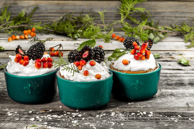 beautiful Christmas cupcake with cream and berry on wooden background cinnamon cones royalty free stock image beautiful Christmas cupcake with cream and berry on wooden background cinnamon cones royalty free stock image